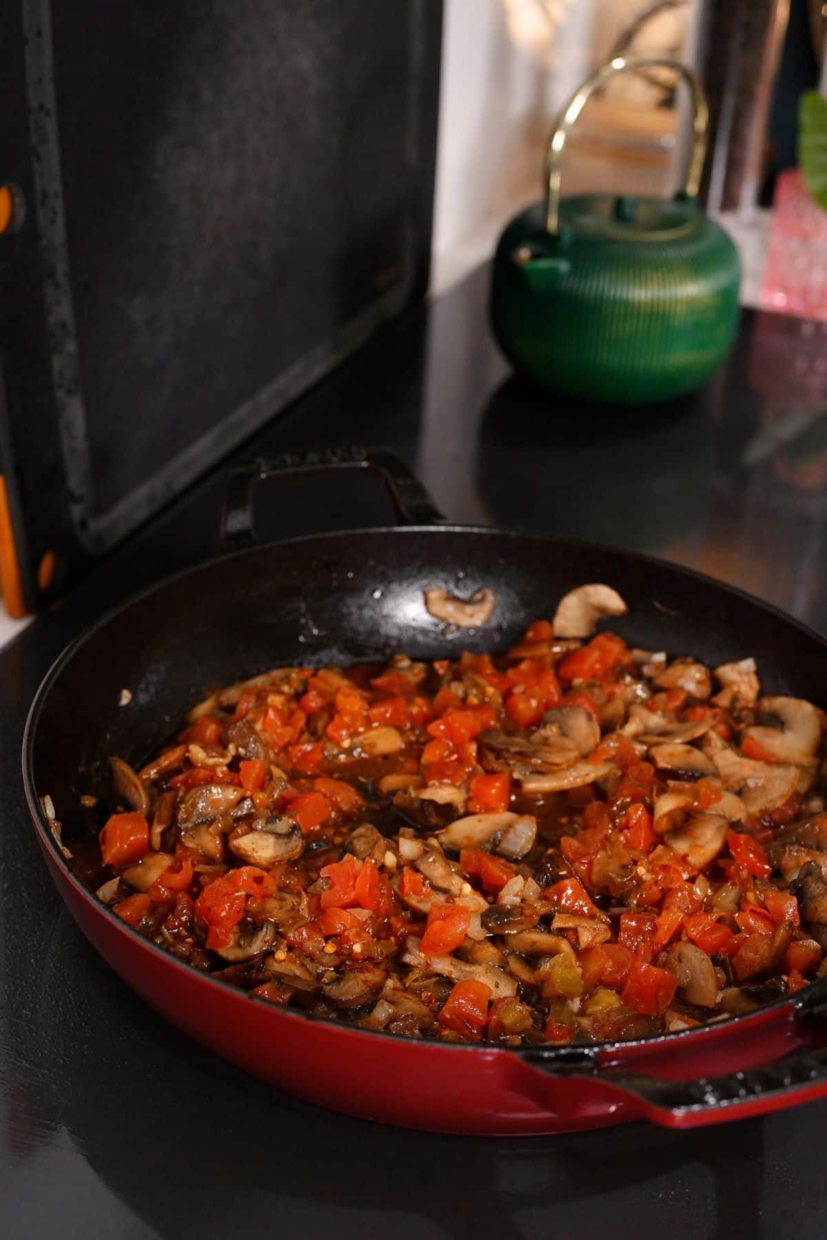 tomatoes, mushrooms, and onions in skillet