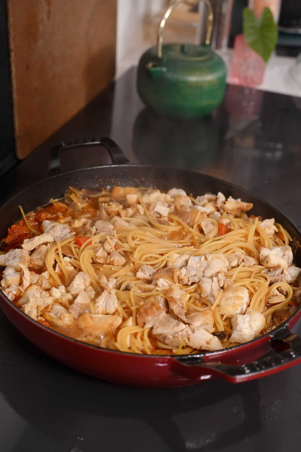 chicken spaghetti cooking in skillet