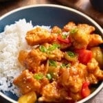 swet and sour chicken in bowl next to rice
