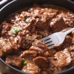 beef tips with gravy with fork picking up beef