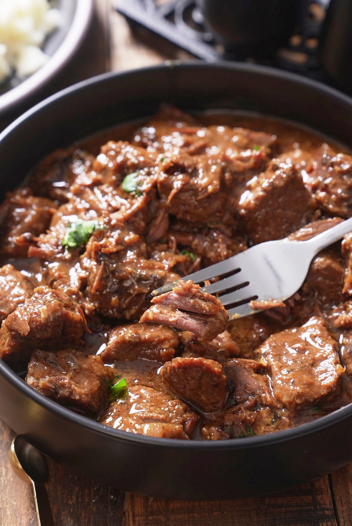 beef tips with gravy with fork picking up beef
