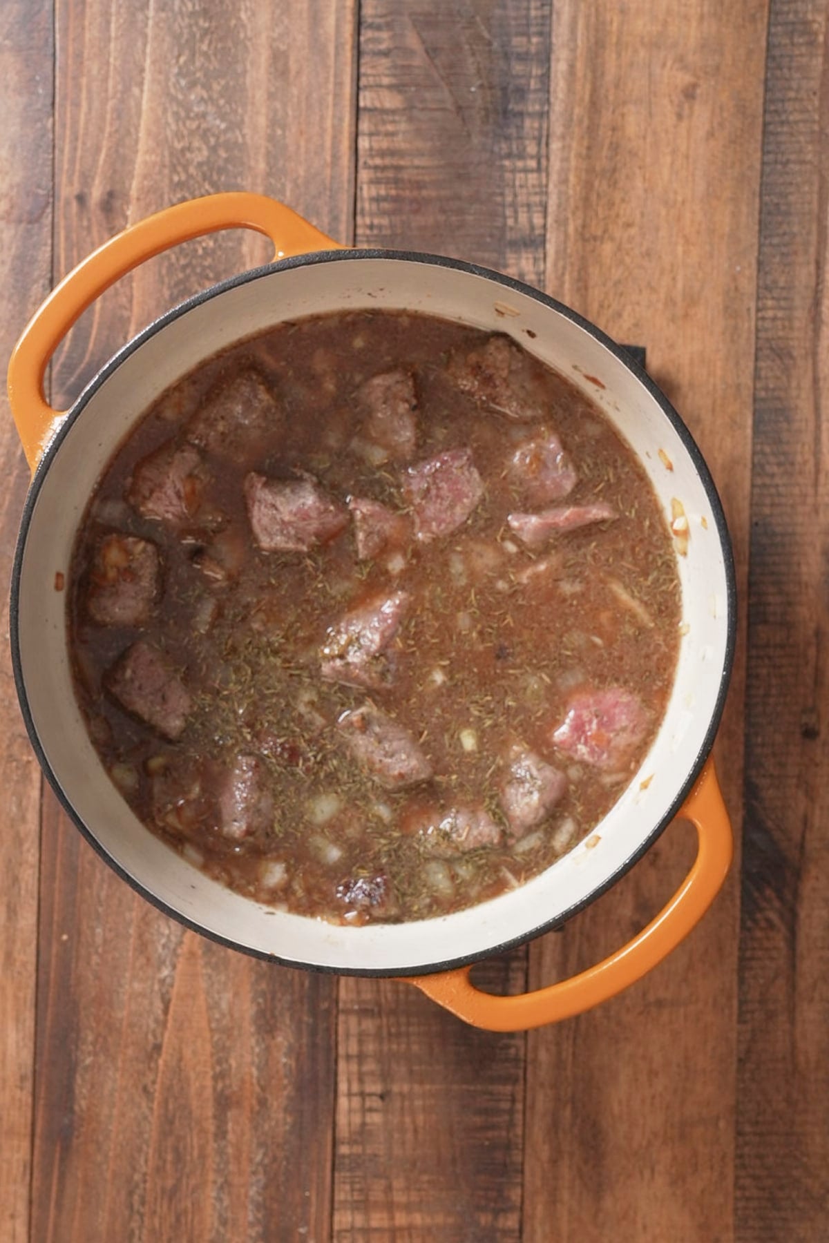 beef tips in pot covered in broth