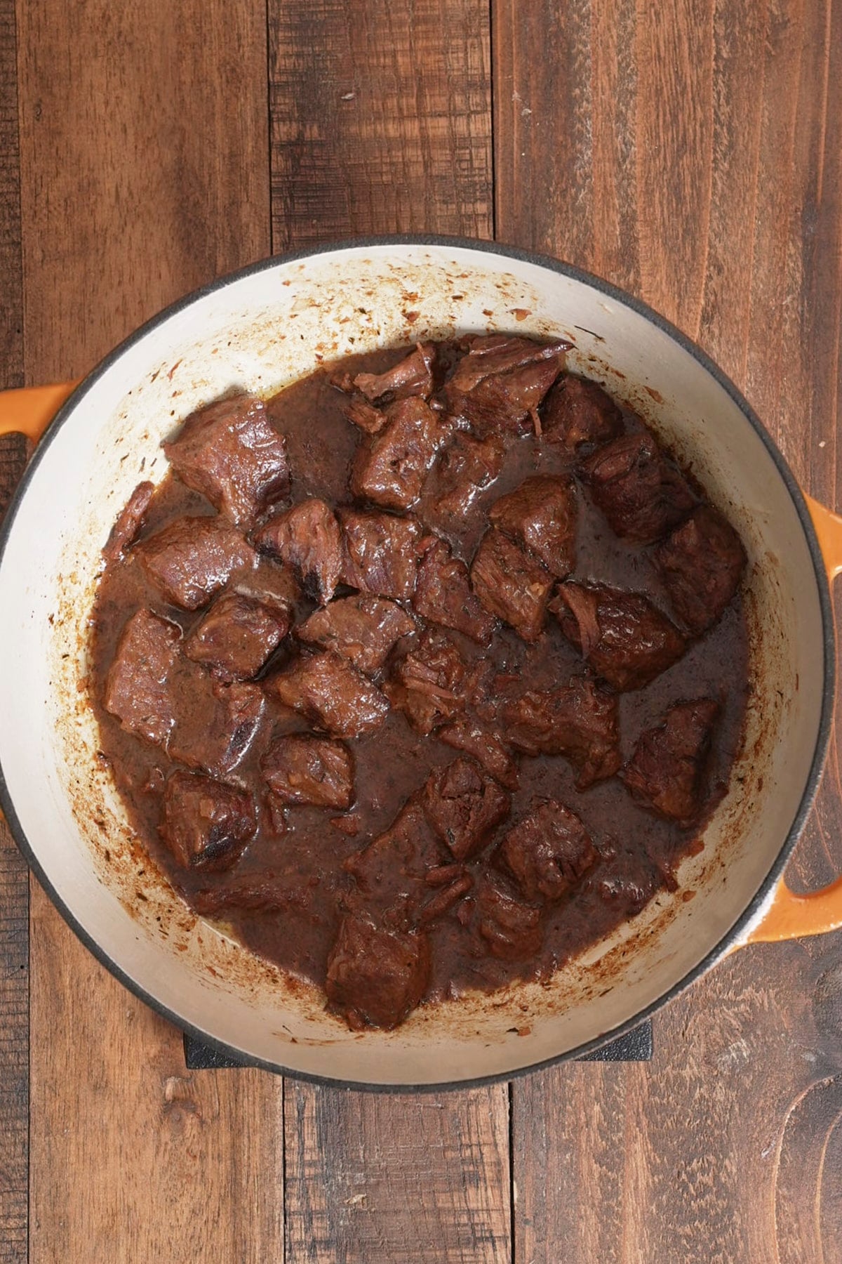 beef tips in pot in gravy after simmering for hours
