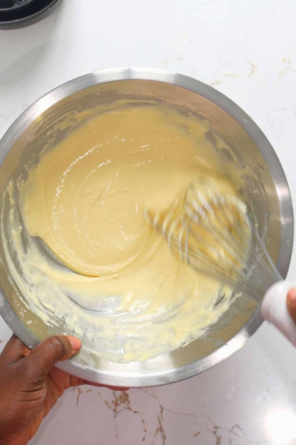 wet batter being whisked in bowl