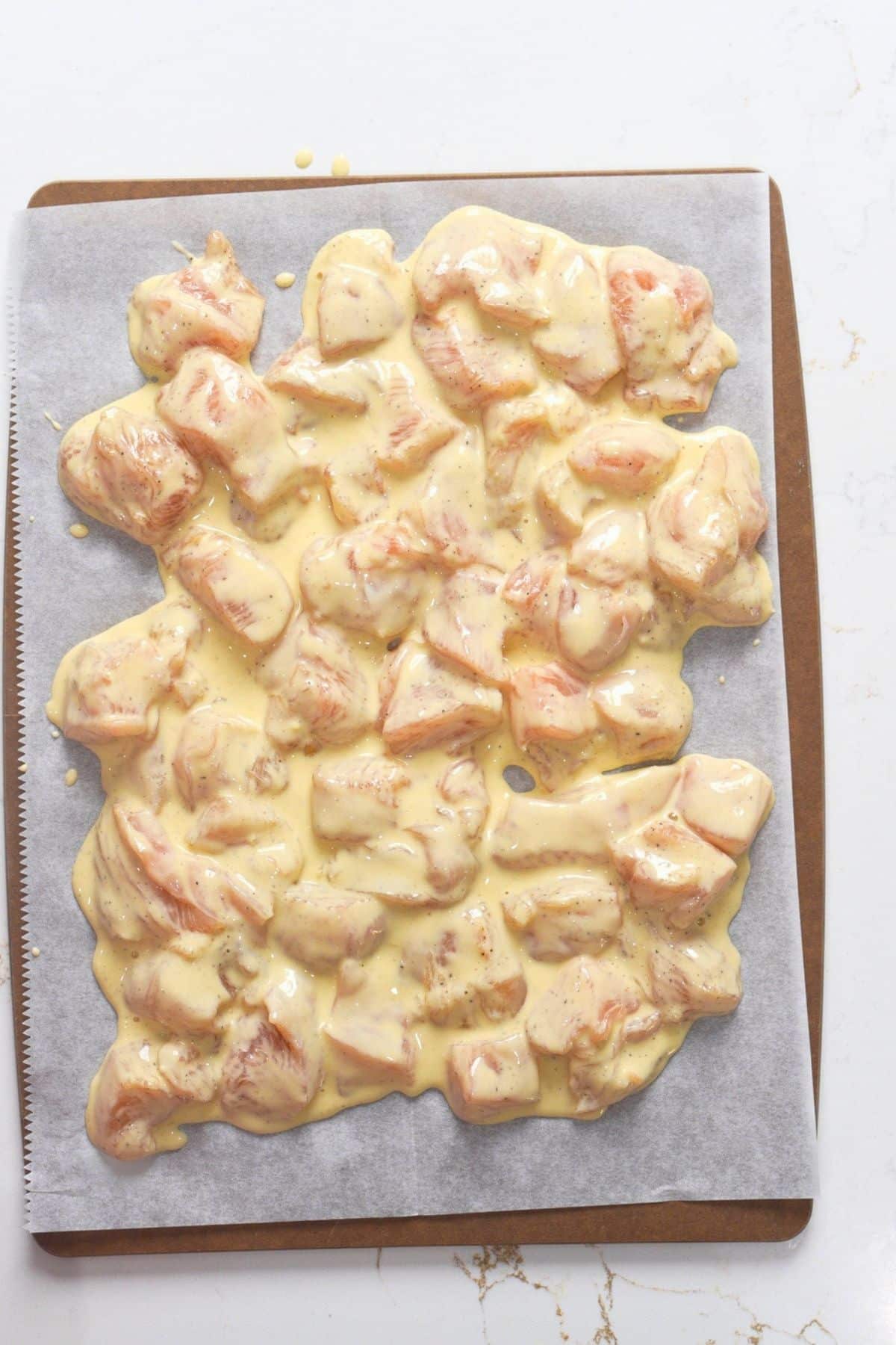 battered chicken on cutting board resting
