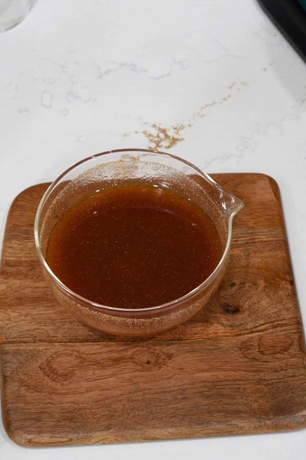 sauce for sweet and sour chicken in glass bowl