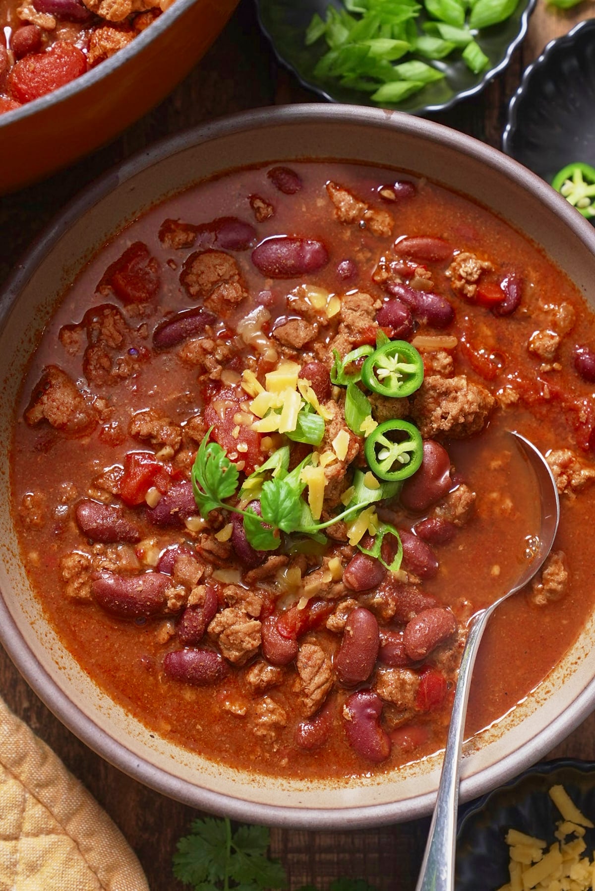 Turkey chili in a bowl with toppings 
