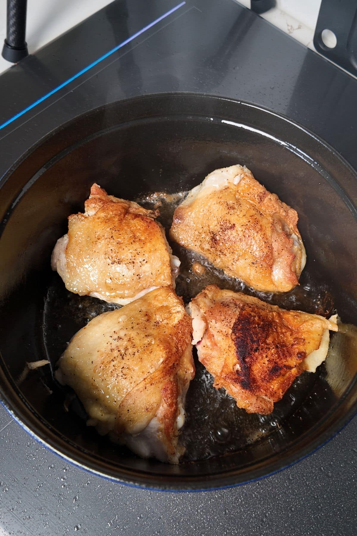 chicken thighs browning in pot