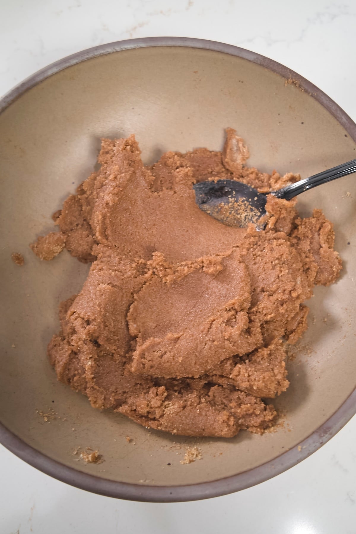 cinnamon sugar and butter mixed together in bowl with spoon