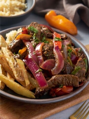 lomo saltado on plate with fries