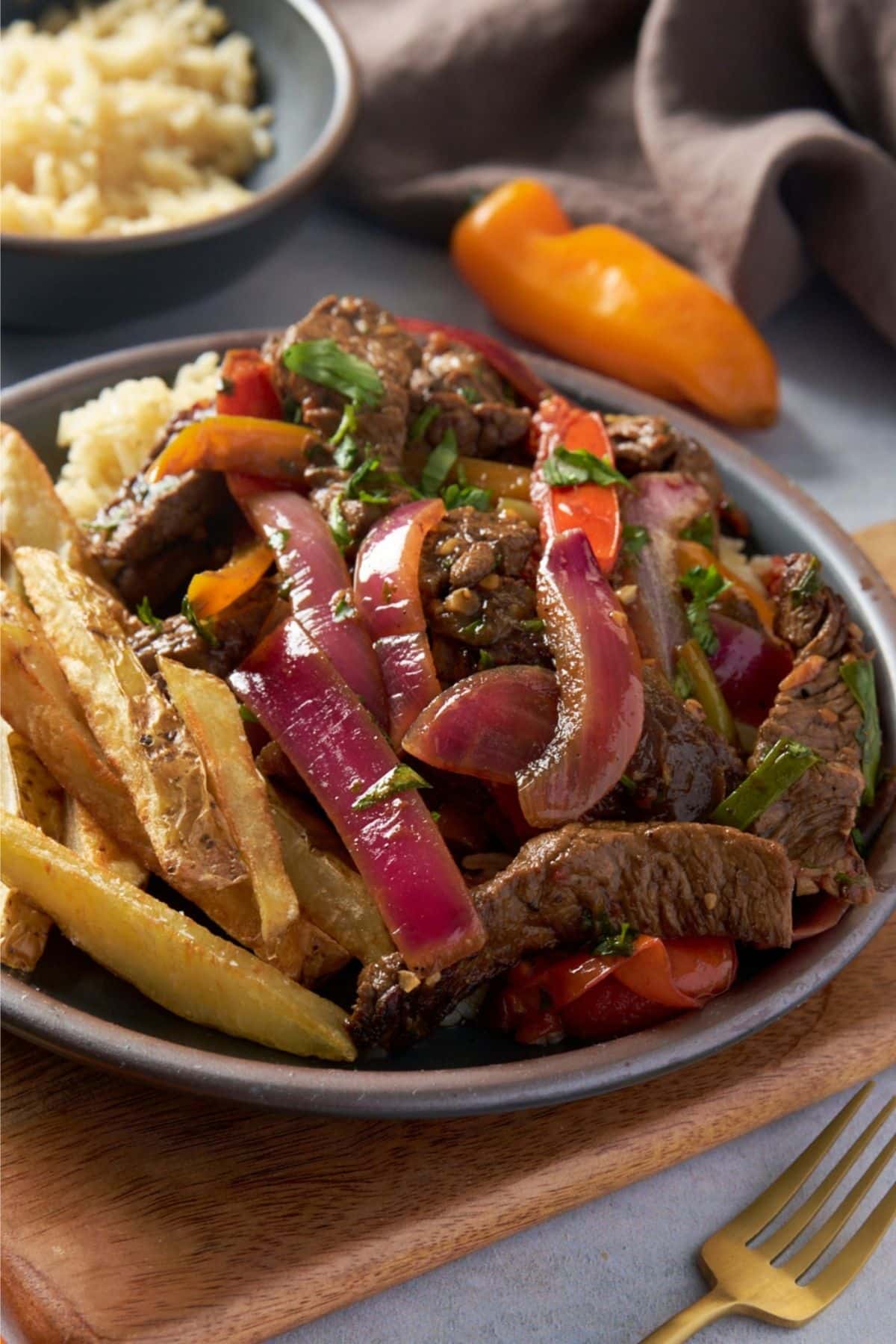 lomo saltado on plate with fries