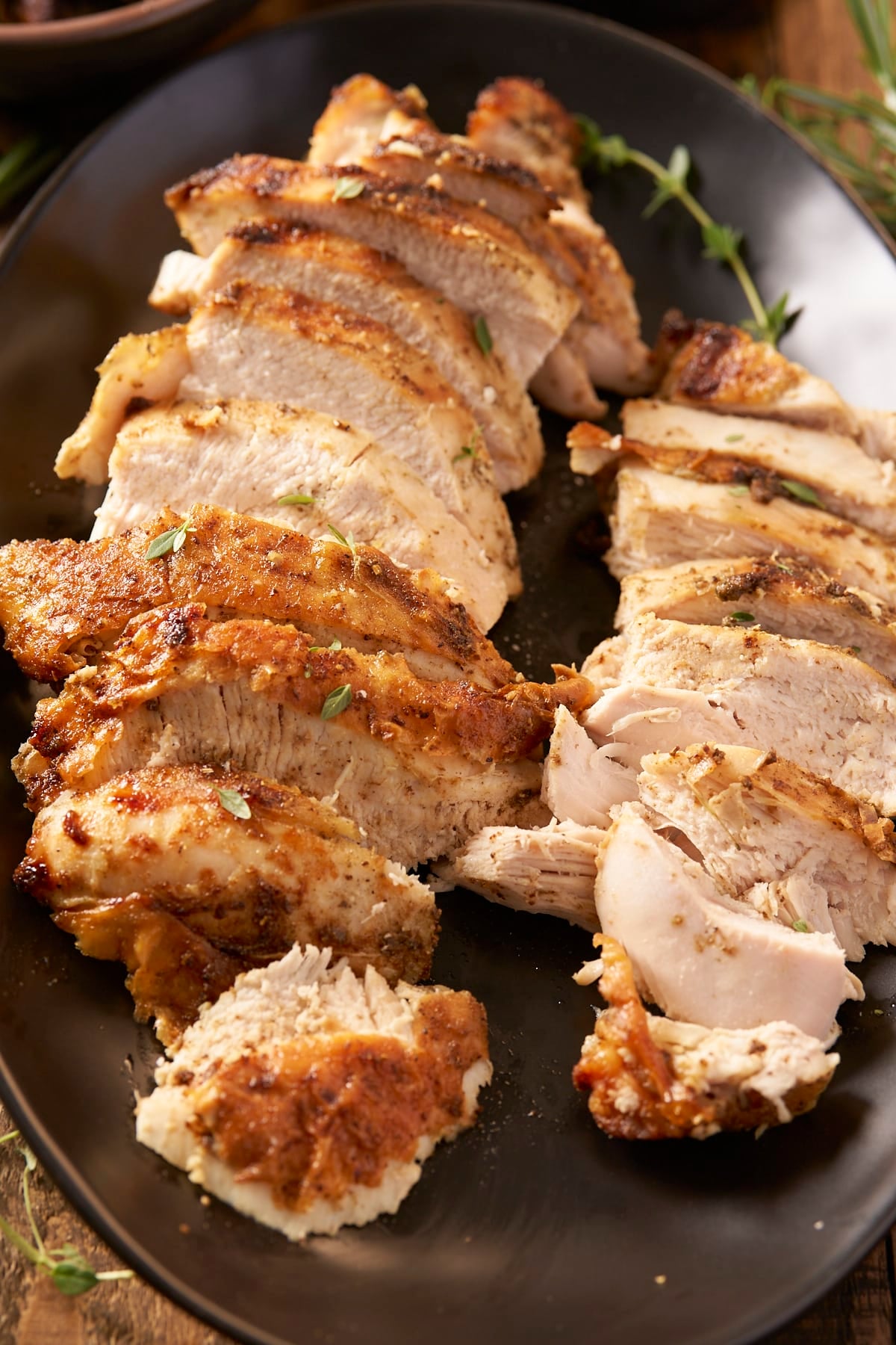 Close-up of turkey breast slices showing moist white meat under seasoned, golden skin