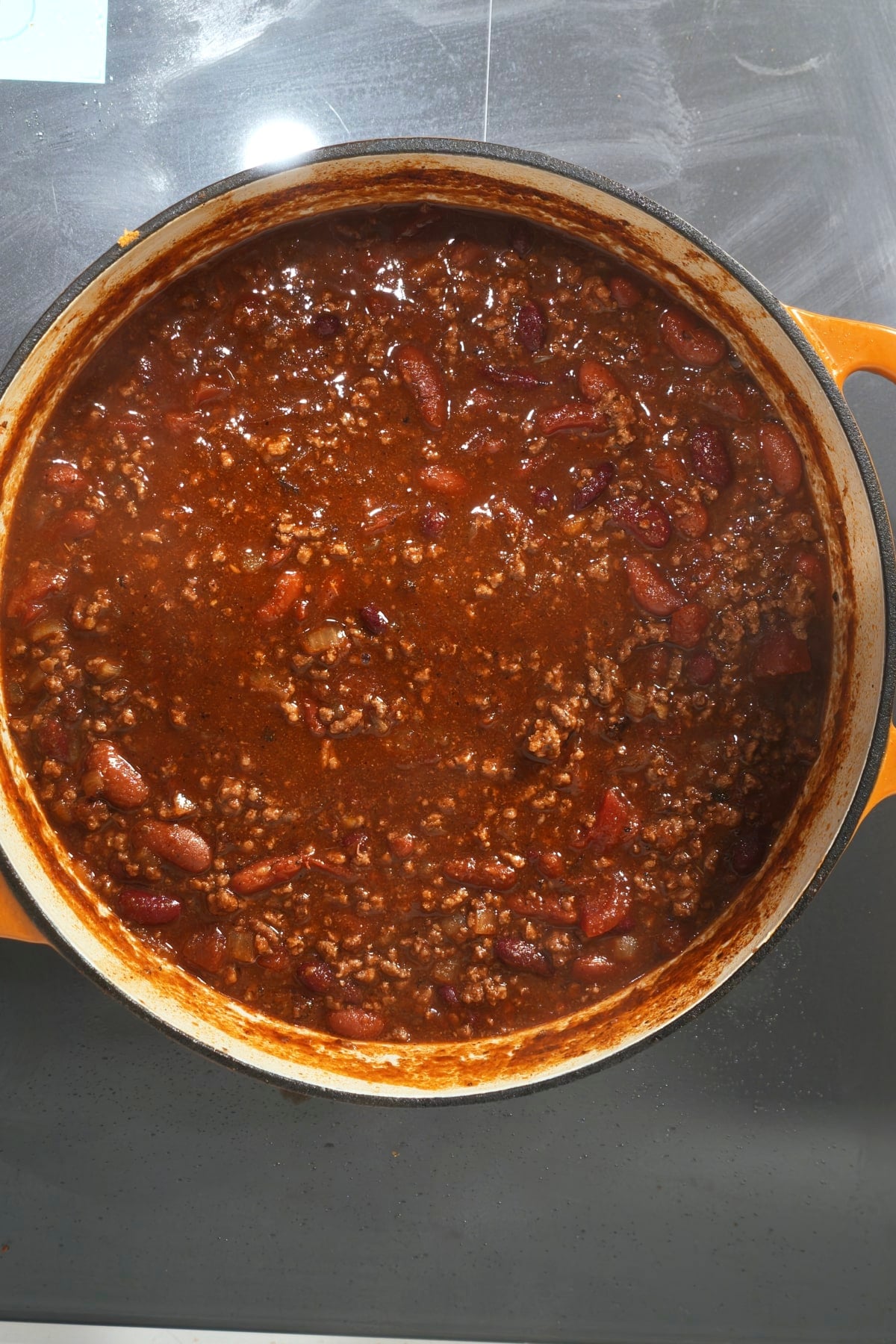 finished beef chili on stovetop in dutch pot