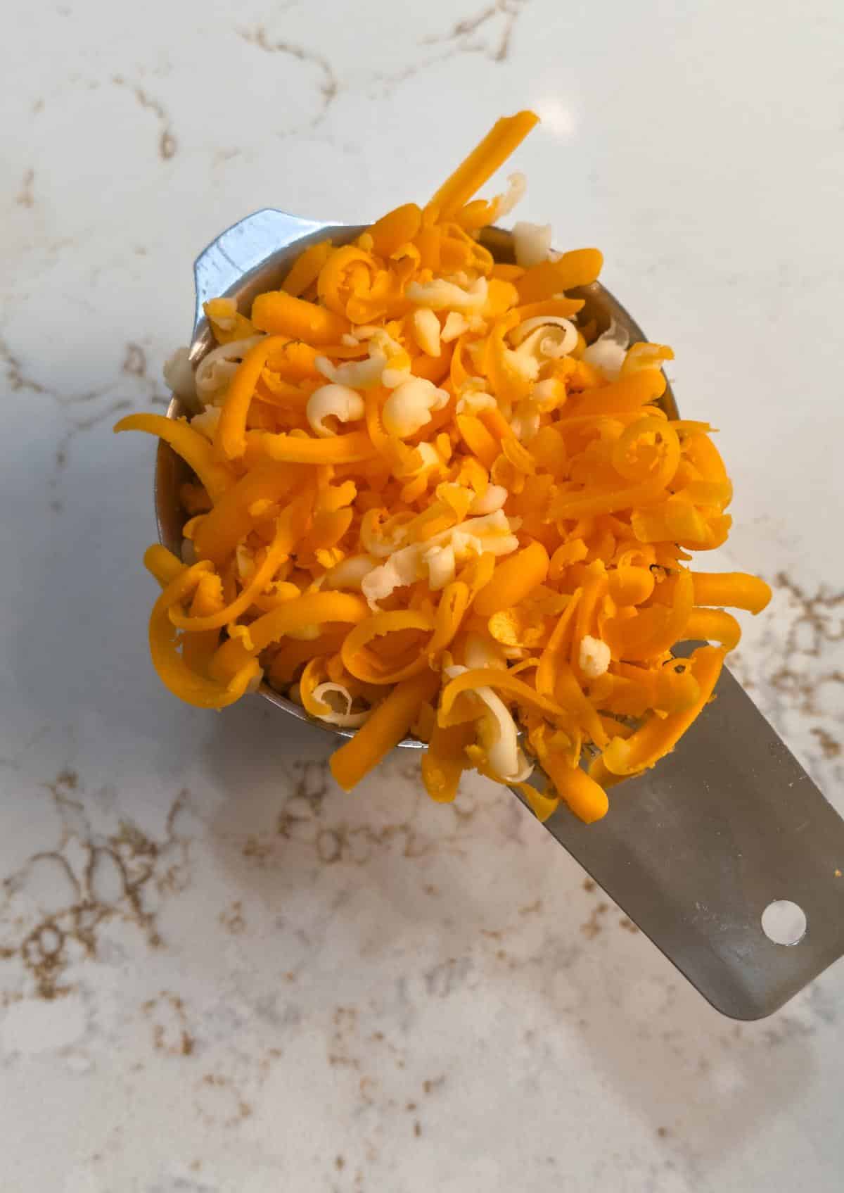 One cup of the shredded cheese blend in a measuring cup, set aside for the top.