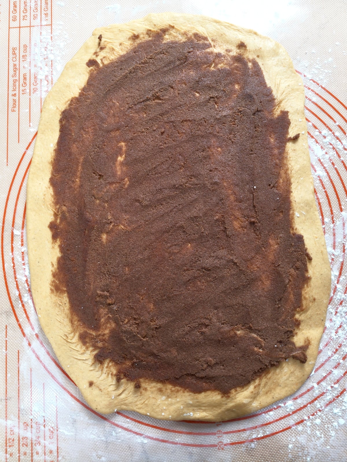 Brown sugar and spice filling spread over the rolled-out dough.